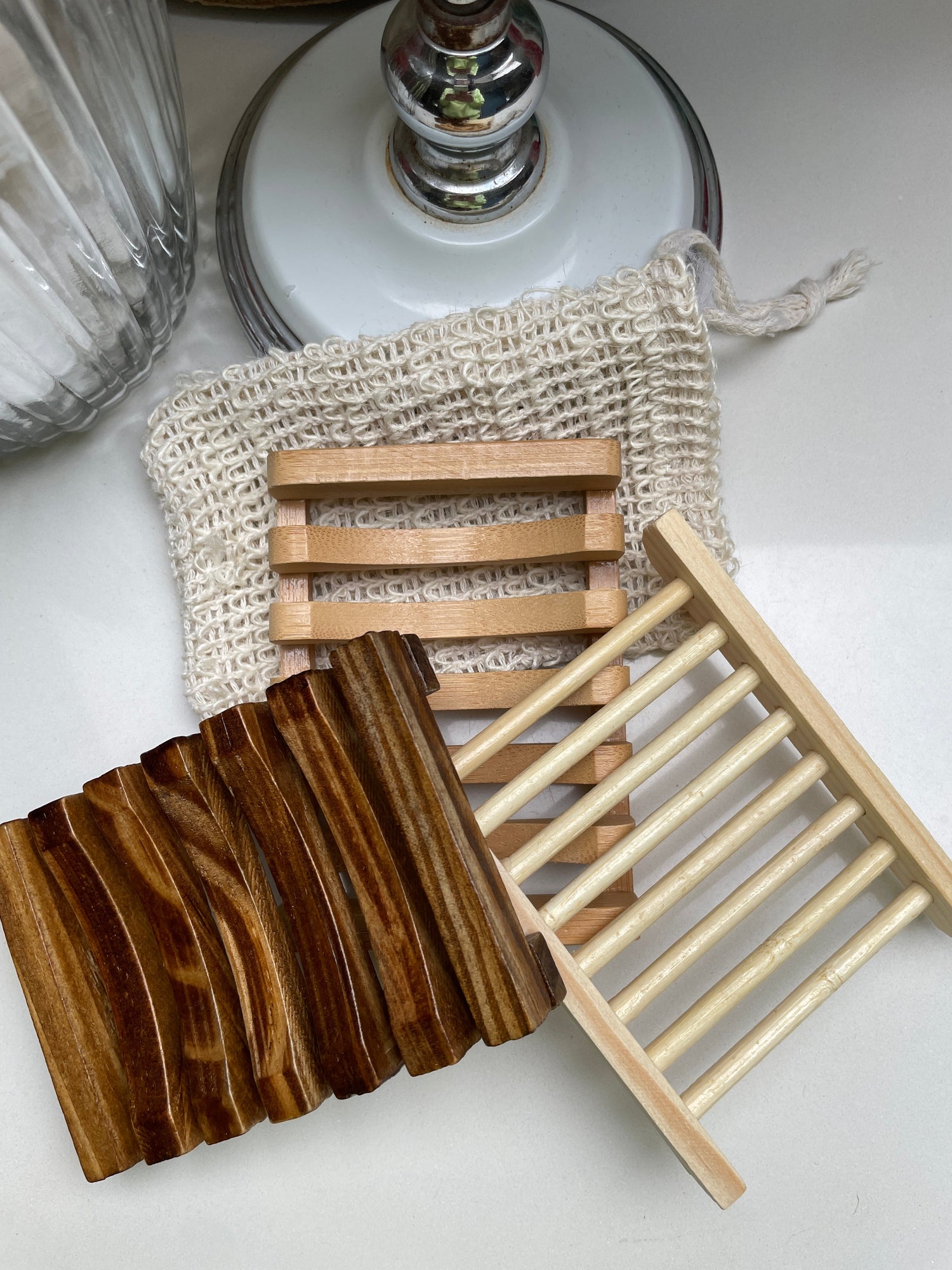 A collection of sisal soap bags and wooden soap dishes.